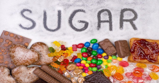 Why Is Sugar Bad for You? The Truth Behind That Sweet Habit: Image showing sugary foods like candies, cookies and chocolates with sugar written on top, highlighting excess sugar consumption and unhealthy eating habits.